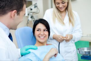 Male dentist and assistant consulting with a patient