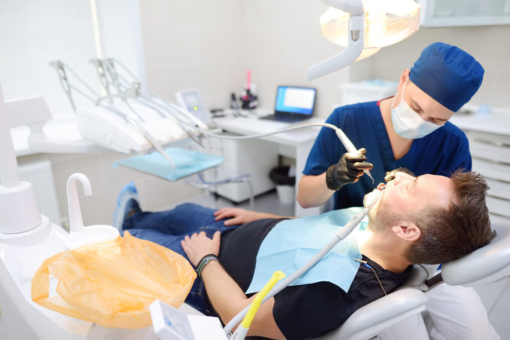 Dentist doing root canal on patient in office