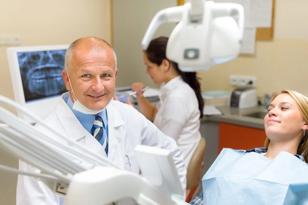 Smiling dentist and female patient in a dental office