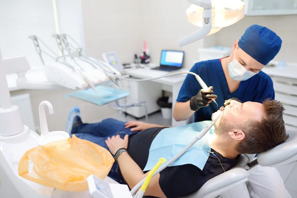 Dentist doing root canal on patient in office
